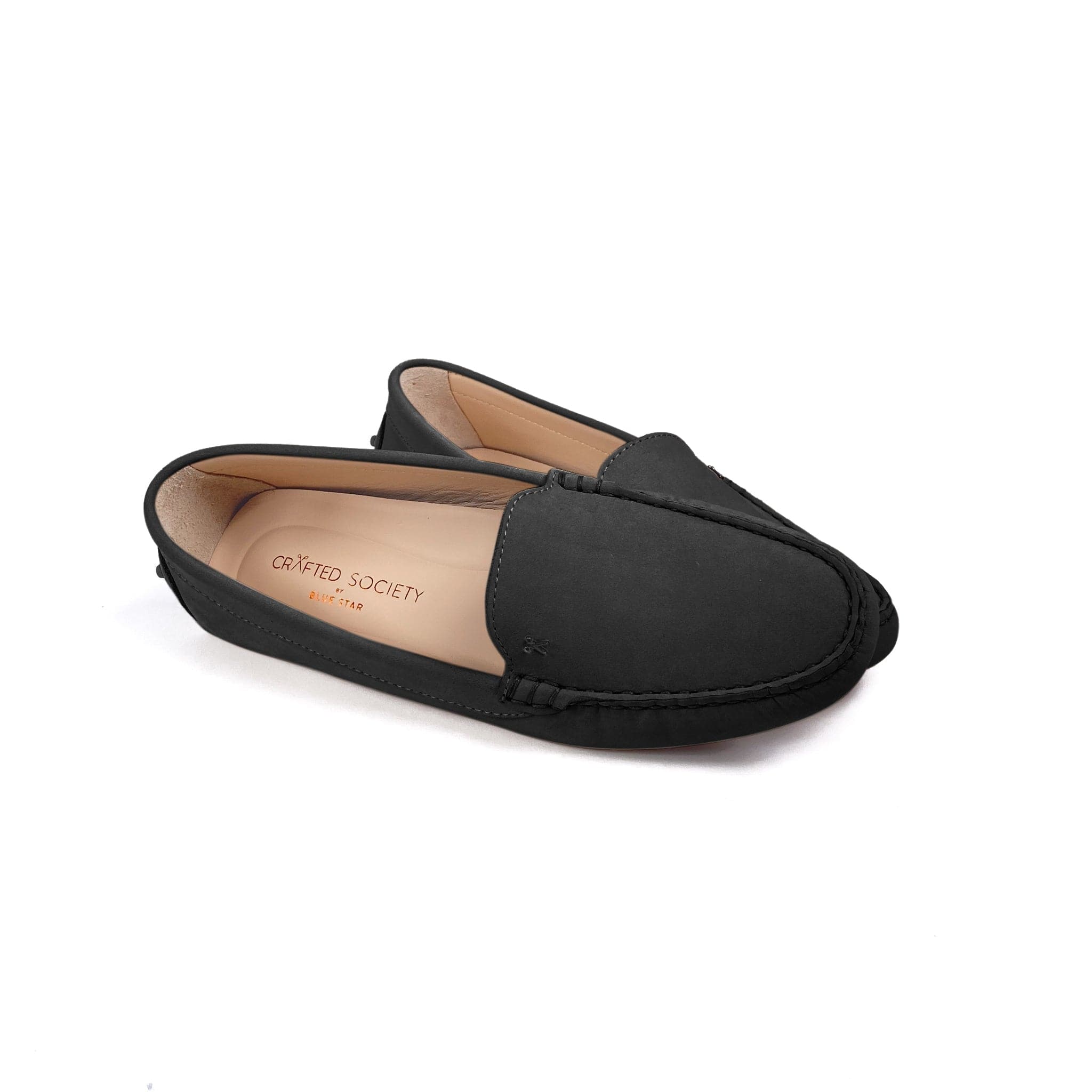 Driving shoe or moccasin in black italian nubuck leather with tan coloured calfskin lining. It has the iconic scissor on the right side of the vamp showing the front and inside on a white background