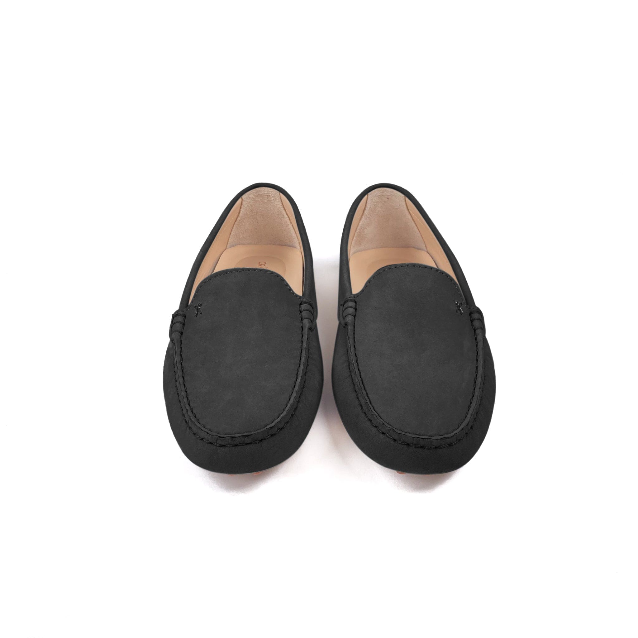 Driving shoe or moccasin in black italian nubuck leather with tan coloured calfskin lining. It has the iconic scissor on the right side of the vamp showing from the front on a white background