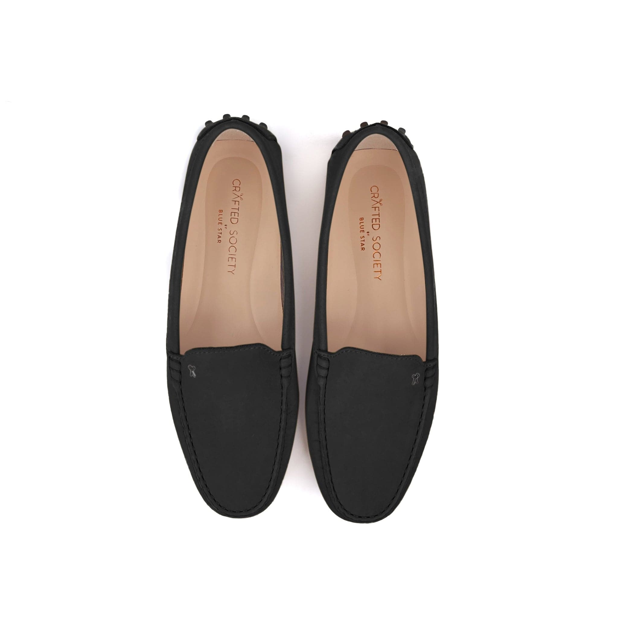 Driving shoe or moccasin in black italian nubuck leather with tan coloured calfskin lining. It has the iconic scissor on the right side of the vamp showing from a top view on a white background